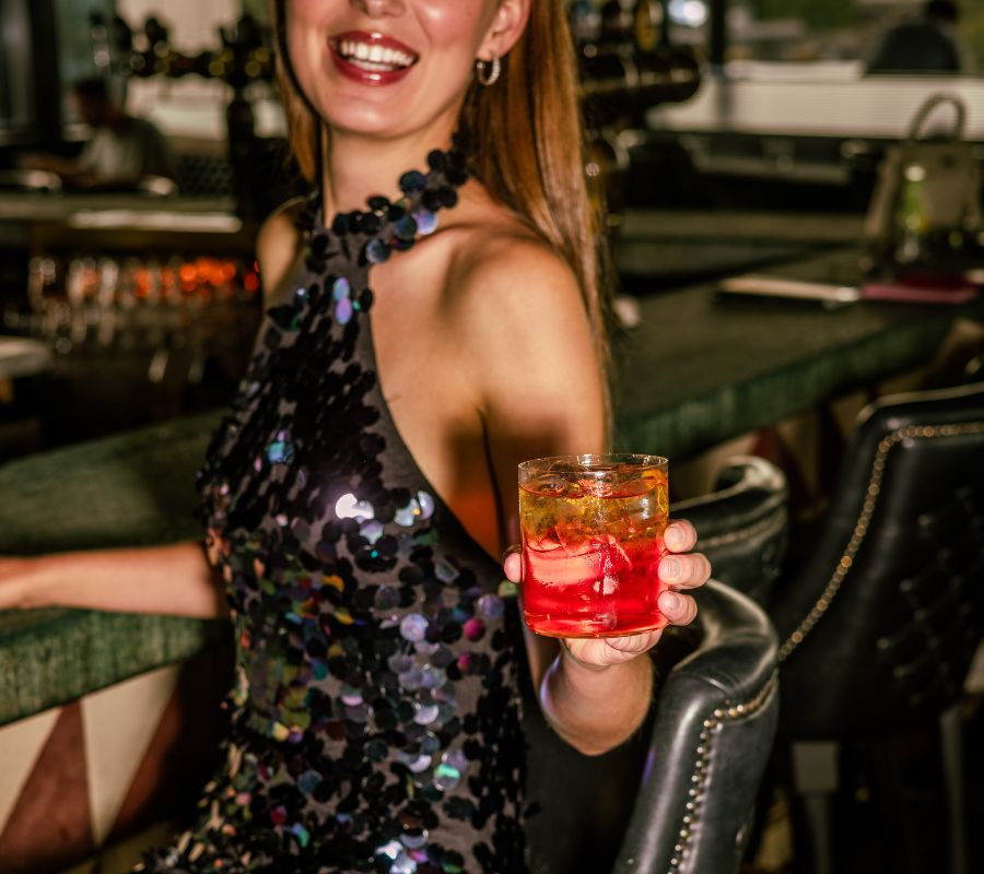 A woman enjoying christmas drinks in a blue dress in a hotel in dublin